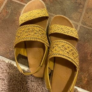 Yellow/gold sandals with detailed pattern and tan sides